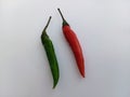 A red and a green chilli pepper on a white background Royalty Free Stock Photo