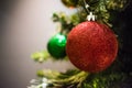 Red and green Christmas decorations on a tree