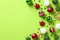 Red and green Christmas ornaments on pastel green background. Xmas greeting card template, Happy New Year banner design. Flat lay Royalty Free Stock Photo