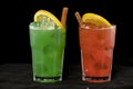 Red and Green Cocktails with red and green juices, alcohol and lime wedge