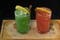 Red and Green Cocktails with red and green juices, alcohol and lime wedge