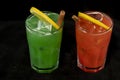 Red and Green Cocktails with red and green juices, alcohol and lime wedge