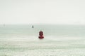 Red and green colored ship buoys on the water surface of a ship passage in the western part of the world Royalty Free Stock Photo