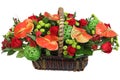 Red-and-green floral arrangement in a wicker basket.