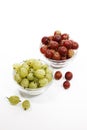 Red and green gooseberries in bowls Royalty Free Stock Photo