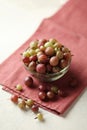 Red and green gooseberries, ripe berries on table in plate Royalty Free Stock Photo