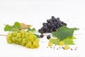 Red and green grapes with leaves on white background Royalty Free Stock Photo