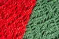Red and green knitted woolen sweater texture.