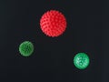 Red and green microbe molecule of the coronavirus virus on dark background.