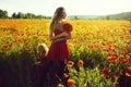 Red and green, mother and child in poppy field Royalty Free Stock Photo