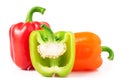 Red green orange bell peppers with half isolated on white Royalty Free Stock Photo