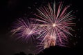 Red green and orange fireworks with sparkling stars