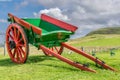 A red and green painted small horse pulled wagon