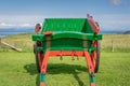 A red and green painted small horse pulled wagon