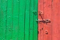 Red and green painted wooden door with bolt Royalty Free Stock Photo