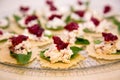 Red and green party snacks on a glass plate