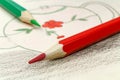 Red and green pencils on the background of a children`s drawing Royalty Free Stock Photo