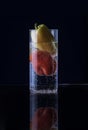 Red and green pepper in a glass of sparkling water Royalty Free Stock Photo