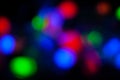 Red, green, pink, blue, blurry christmas and holiday lights in the dark. Multicolored, bright blurred bokeh background Royalty Free Stock Photo