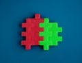 Red and green puzzle blocks are perfectly put together on blue background, minimal style. Royalty Free Stock Photo