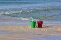 Red and Green Sand Buckets on Beach Royalty Free Stock Photo