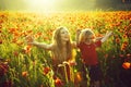 Red and green, smiling mother and child in poppy field Royalty Free Stock Photo