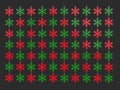 Red and green snowflake Christmas tree decorations - dark gray background