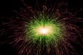 Red and green sparks of a festive New Year's light. Sparks fly in different directions from the burning sparkler. Royalty Free Stock Photo