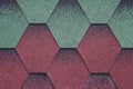 Red and green surface of roofing tiles. Cover of shape of rhombus. Dark roof tile, grunge background. Abstract mosaic of bricks ba Royalty Free Stock Photo