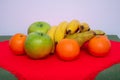 Tablecloth with pears, bananas, oranges and fresh green apples Royalty Free Stock Photo