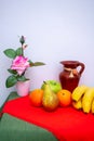 Red and green tablecloth with pears, bananas, oranges and fresh green apples Royalty Free Stock Photo