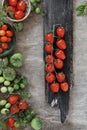 Red and green tomatoes on wooden background, cooking food. Rustic food background, top view