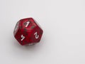 Red and green twelve-sided die displaying a 1