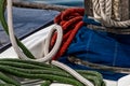 Red, Green and White Ropes With Blue Sail Cover in Contrast