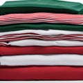 Red, green and white T-shirts lie in a stack. The concept of diversity in the world and freedom of choice