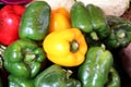 Red, green, yellow bell peppers at a market Royalty Free Stock Photo