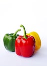 Red green yellow bell peppers raw food on white backgrounds Royalty Free Stock Photo