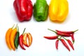 Red green yellow sliced chilli bell and bird& x27;s eye pepper isolated on white background