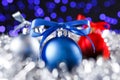 Red, grey and blue christmas balls, blured purple lights at the background Royalty Free Stock Photo