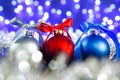 Red, grey and blue christmas balls, blured purple lights at the background Royalty Free Stock Photo