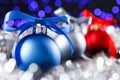 Red, grey and blue christmas balls, blurred purple lights at the background Royalty Free Stock Photo