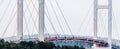 A red and grey cable-stayed bridge