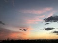 Red and grey clouds in the sky at different times