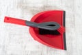 Red and grey dustpan and brush Royalty Free Stock Photo