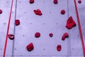 Red and grey rock climbing wall with carabiner hook and climbing