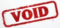 Red grunge rectangle stamp with the word VOID is printed on white background. This signifies rejection, cancellation, or Royalty Free Stock Photo