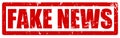 Red grunge stamp with a text FAKE NEWS to show that the information is not true or it is intentionally misleading Royalty Free Stock Photo