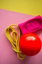 Red gymnastic ball, kneepads and skipping rope on a duotone back Royalty Free Stock Photo