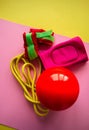 Red gymnastic ball, kneepads, weightings and skipping rope on a Royalty Free Stock Photo