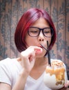 Red hair asian nerdy girl having chocolate shake